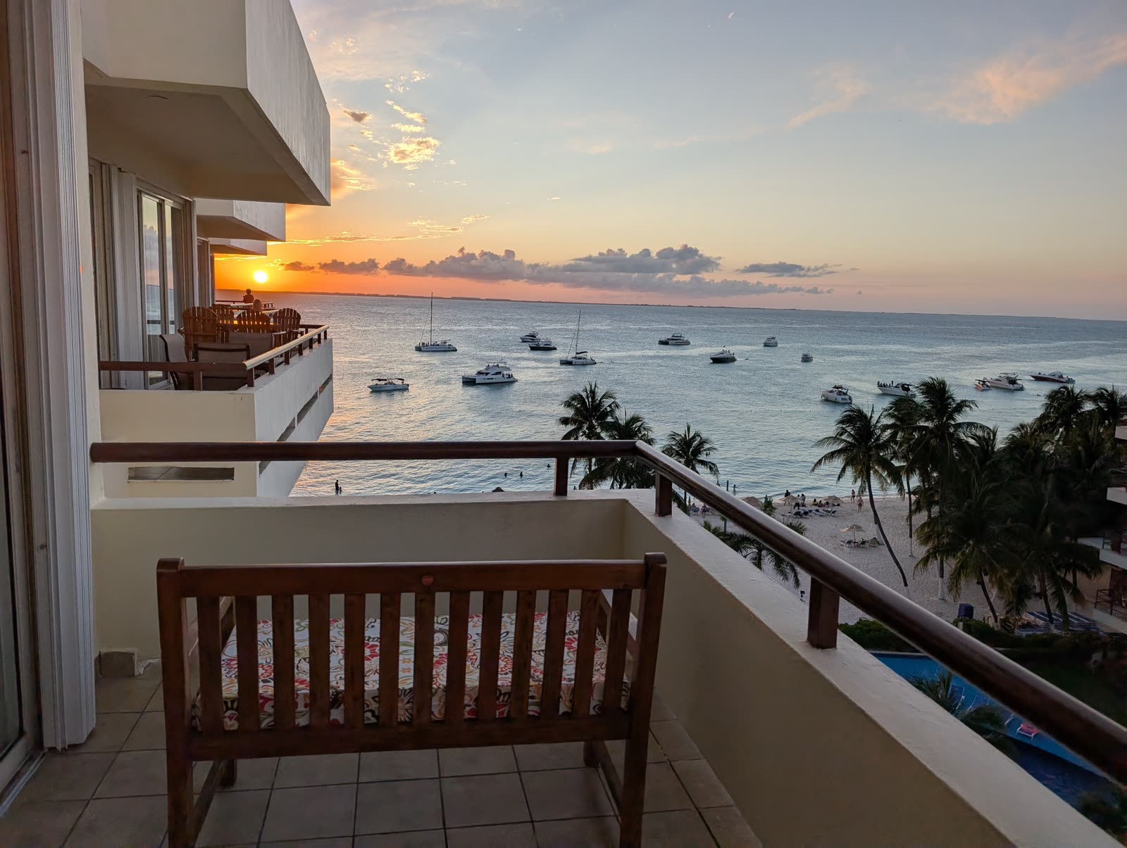 Sunset view from Suite 604 balcony at Ixchel Beach Hotel, Playa Norte with sailboats and Caribbean